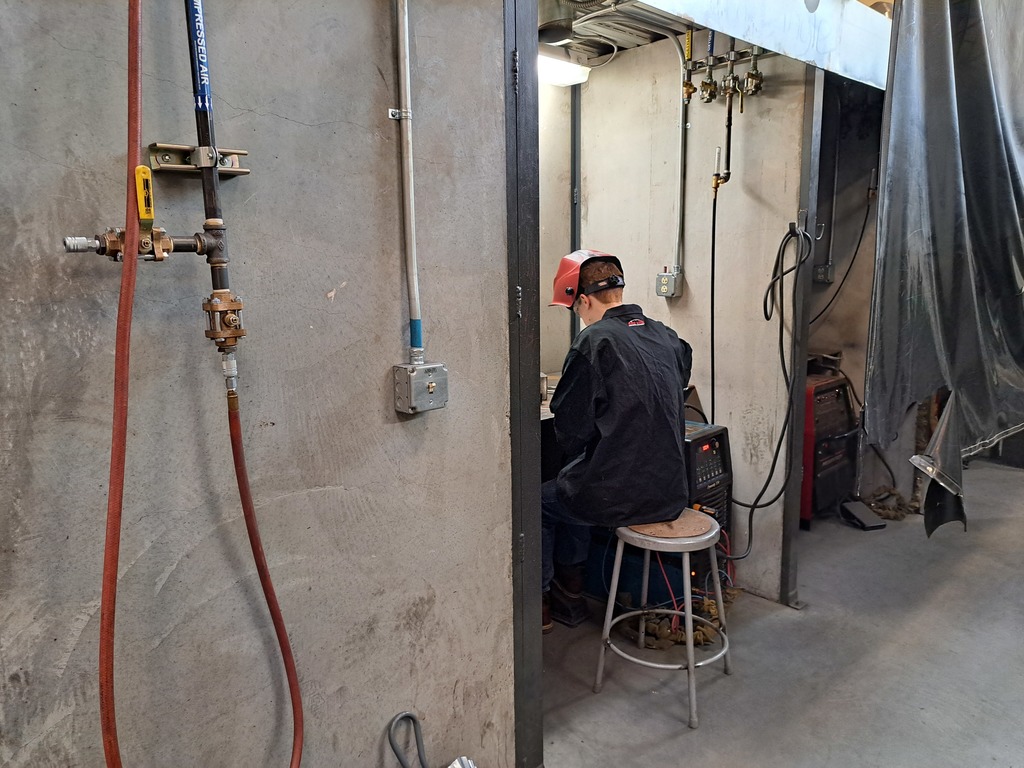 student wearing black welding